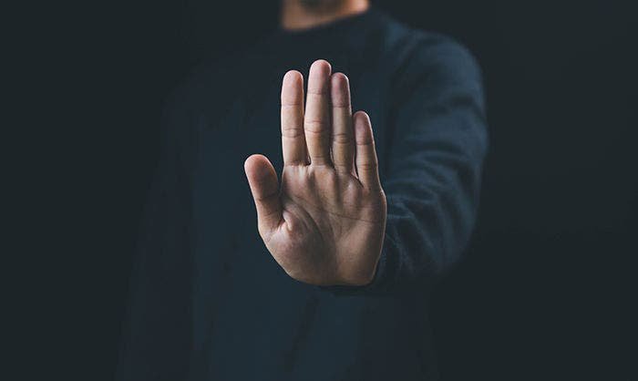 the hand sign of men a stop, caution.