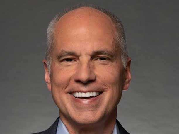 A person smiling at the camera AI-generated content may be incorrect.