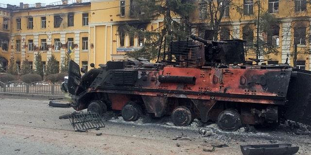 A destroyed armored vehicle is seen in front of a school which, according to local residents, was on fire after shelling, as Russia's invasion of Ukraine continues, in Kharkiv, Ukraine, Feb. 28, 2022. 