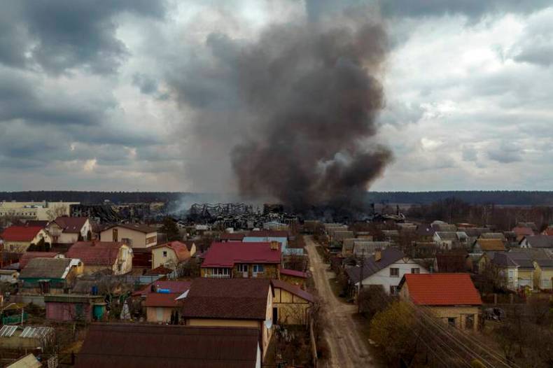 A factory and a store burn after being bombarded in Irpin, on the outskirts of Kyiv, Ukraine on March 6.
