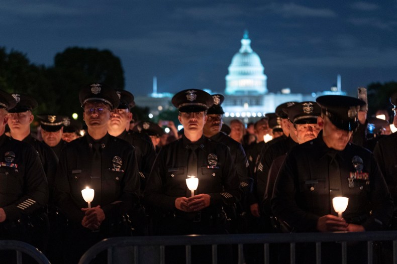 Law enforcement personnel hold candles during the 34th Annual Candlelight Vigil to commemorate new names added to the National Law Enforcement Officers Memorial in a ceremony at the National Mall in Washington, Friday, May 13, 2022. (AP Photo/Jose Luis Magana)