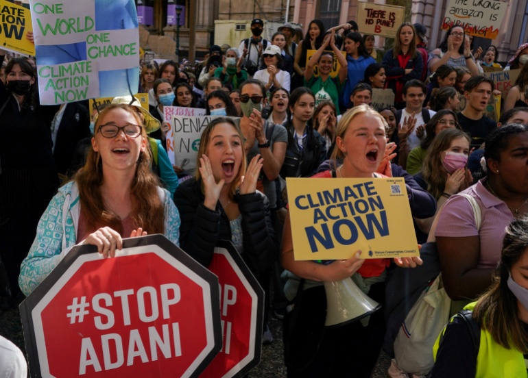Young students demand further action on climate change carrying banners saying 'Stop Adani' and 'Climate Action Now'