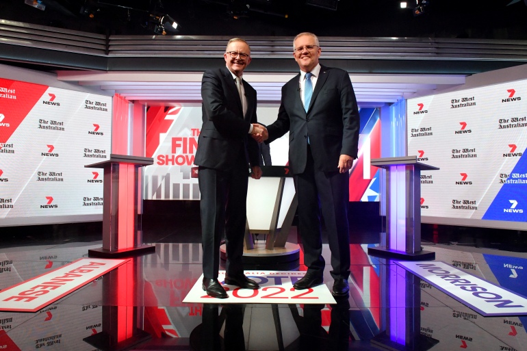 Australian Prime Minister Scott Morrison (R) and leader of the opposition, Anthony Albanese , shake hands at the third leaders' debate of the 2022 federal election campaign in Sydney
