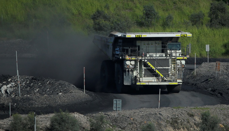 A coal truck drives inside Rio Tinto's Hunter Valley operations in Lemington, NSW sending up clouds of coal dust 