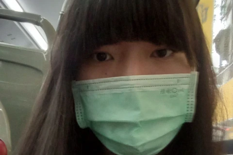 Photo of woman with straight dark fringe in mask