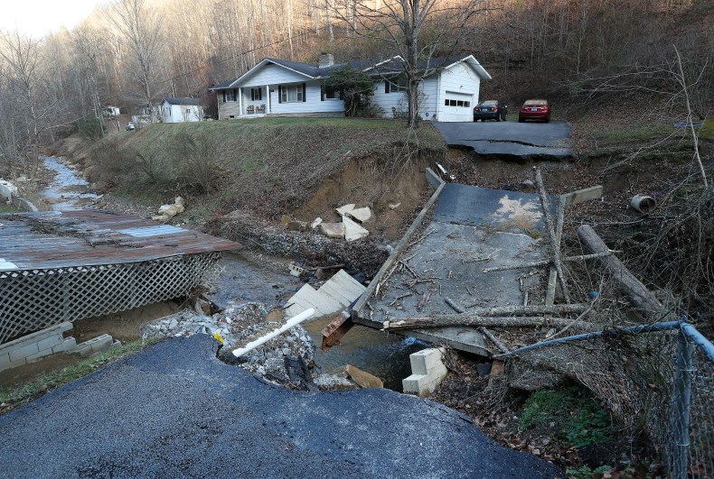 The floodwaters that tore through Caney Creek in July were so strong, the decades-old bridge connecting Ian and Kasie Hall's home to the road crumbled. The bridge is estimated to cost $100,000 to $200,000 to repair. (Photo: Sam Upshaw Jr./Courier Journal)