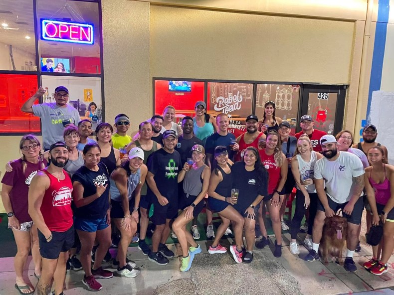 Members of the Downtown Corpus Christi Run Club pose for a photo outside of Rebel Toad Brewing Co. in downtown Corpus Christi in September 2022. The club meets every Wednesday evening to run 2 or 5 miles.