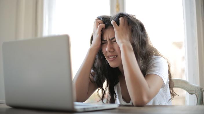 Woman stressed out looking at her computer