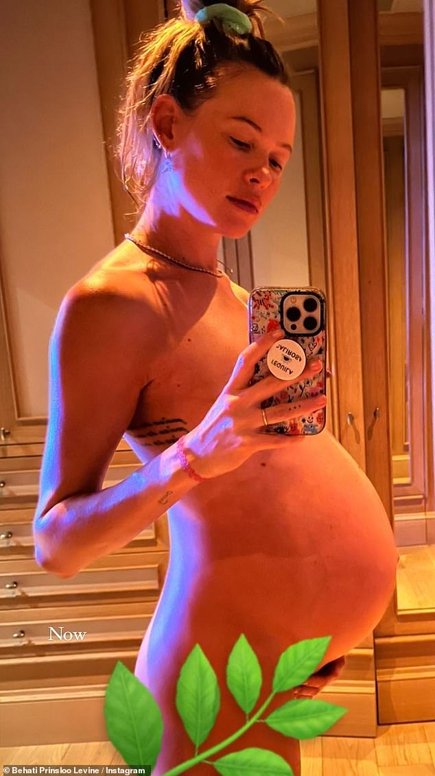'Now': The last photo shared was another mirror selfie of Behati as she posed fully nude to show off her burgeoning bump