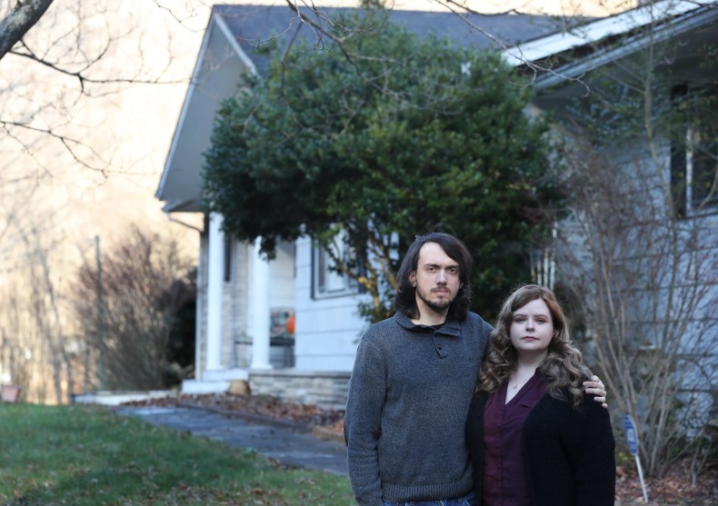 Ian Hall, left, and his wife Kasie Hall, outside their home on Dec. 12, 2022, are frustrated that an access bridge to the driveway of their home in Pippa Passes, Kentucky, has not been repaired for months after being destroyed by flooding. (Photo: Sam Upshaw Jr./Courier Journal)