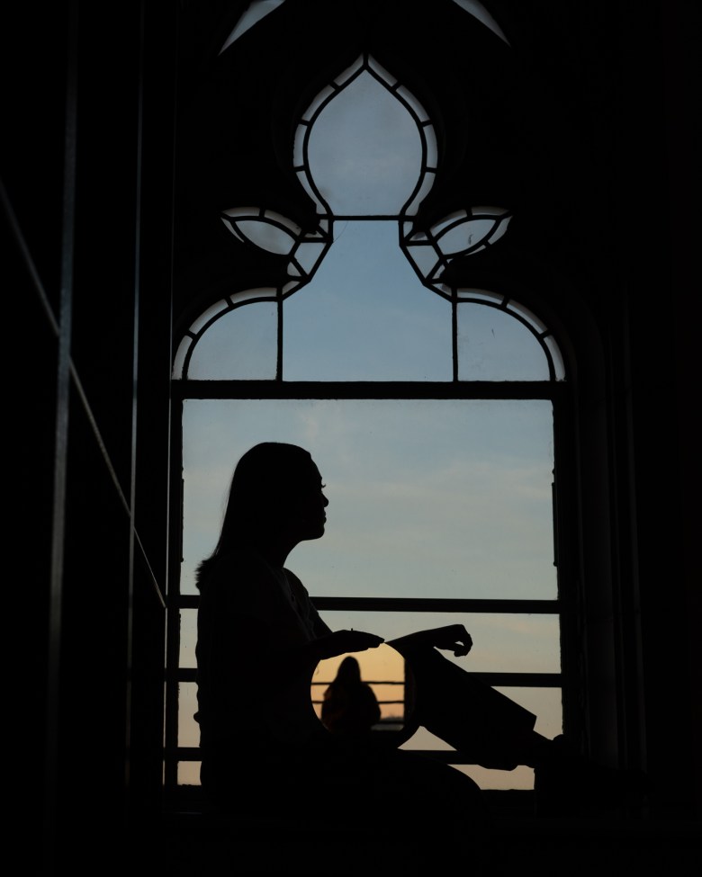 Beth, a University of Pittsburgh senior, sits for a portrait in the Cathedral of Learning on campus on Sunday, Oct. 2, 2022, in Oakland. (Photo by Stephanie Strasburg/PublicSource) 