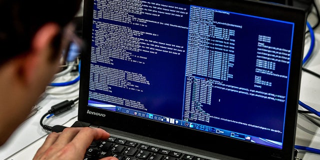 A person works at a computer during the 10th International Cybersecurity Forum in Lille Jan. 23, 2018. 