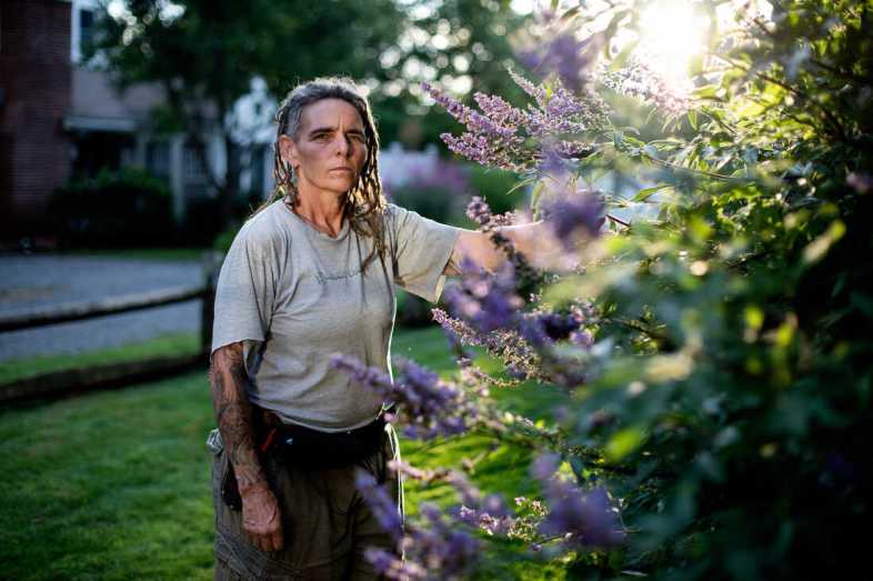 Candy Crawford, of Handy Candy landscaping, in a client's garden in Provincetown, Mass. She received a $1,022 PPP loan through PayPal that was later sold to another company. It took her more than two years to get it forgiven.
