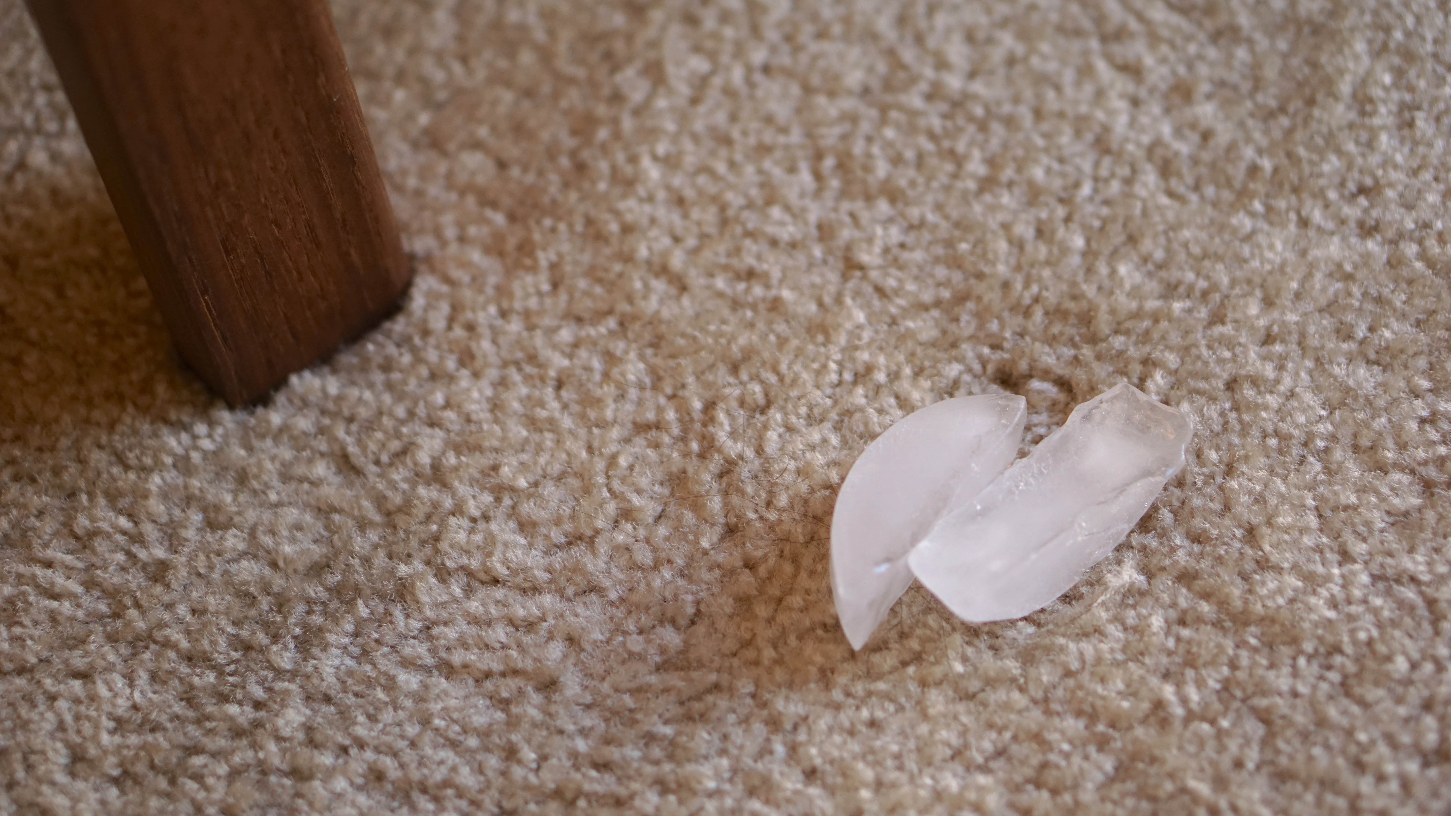 Two ice cubes on carpet dent