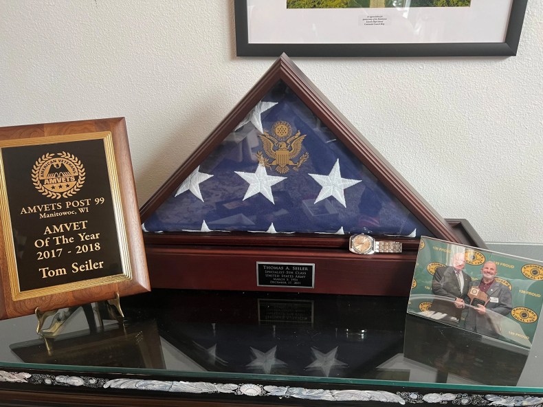 Thomas A. Seiler's Timex watch, recently returned to his family by his sergeant, Stephen (Shorty) Menendez, is shown with his folded flag representing his military service.