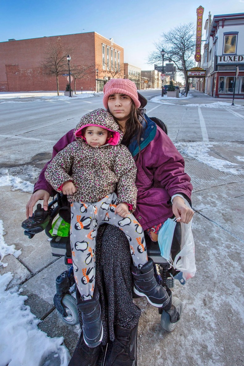 Ashley Lagoo-Mckinnie and her daughter Lyanna Brown-Lagoo pose on the corner near the Above and Beyond Children's Museum, Friday, January 28, 2022, in Sheboygan, Wis. Ashley McKinnie is the handicap mother of a young daughter living in a shelter in Sheboygan. Ashley is wheelchair bound and the shelter has everyone leave in the morning and they canÕt return until the late afternoon, no matter what the temperature outside is. 