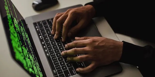 Man typing on laptop