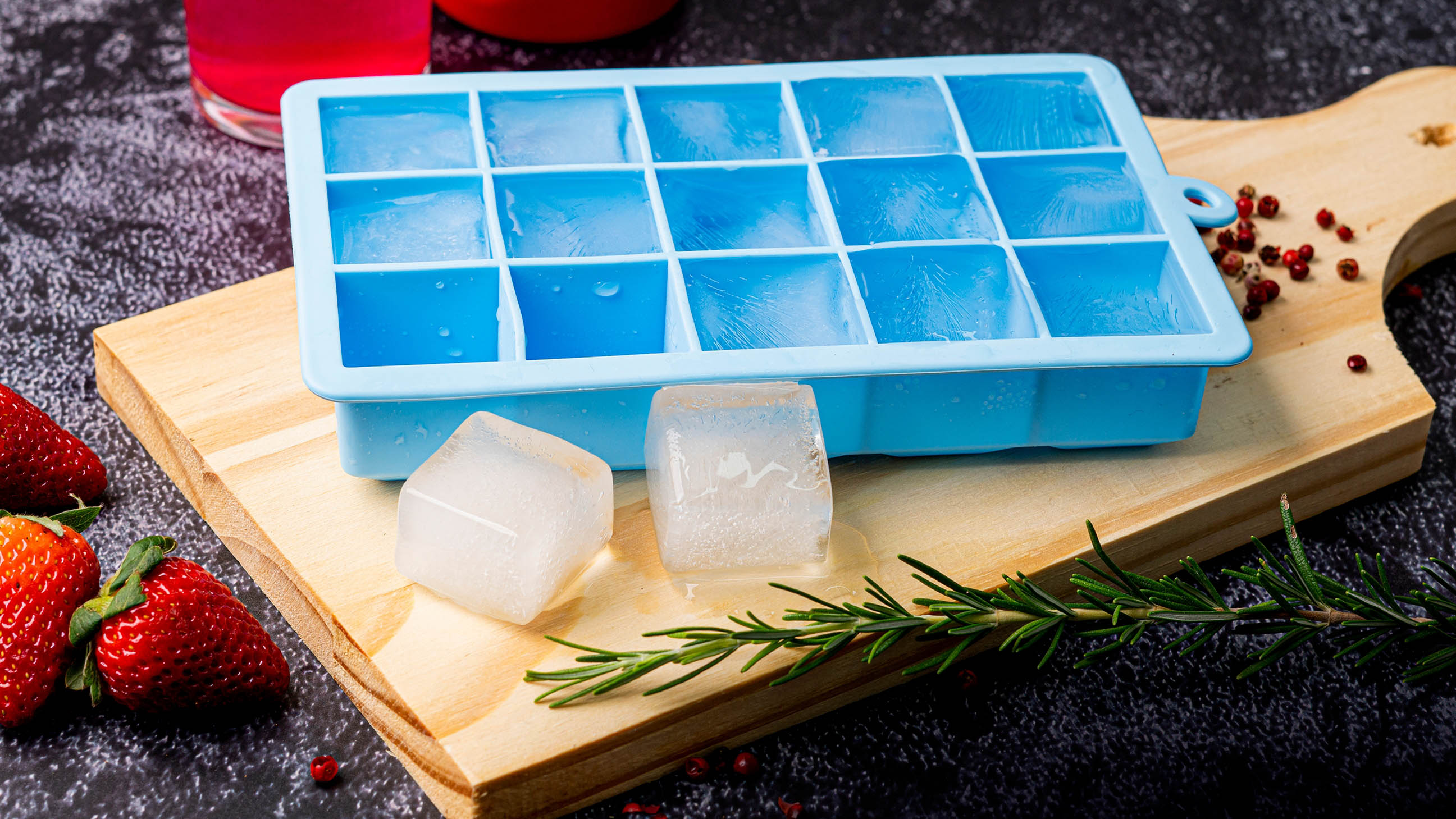 Ice cubes in a tray on a cutting board