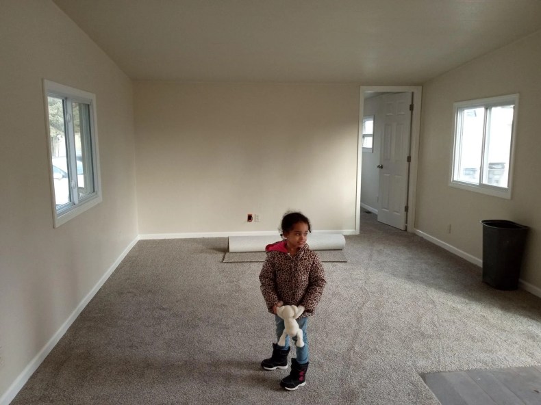 Mckinnie's three-year-old daughter standing in her new room at the mobile home she was approved to purchase.