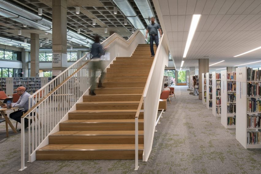 Shallow timber staircase connecting levels within public library by Hacker Architects