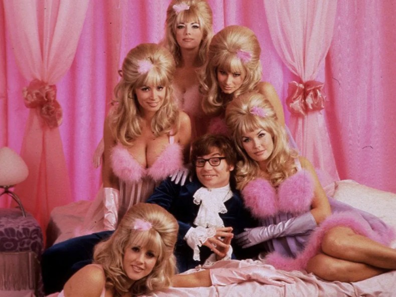 Mike Myers as the titular character, surrounded by the gorgeous but lethal Fembots, in Austin Powers: International Man of Mystery.