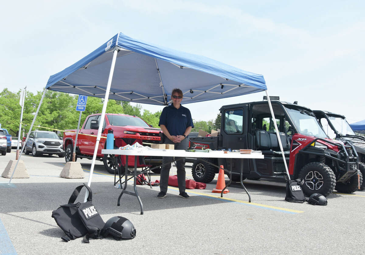 Detective Sgt. Kirsten Goodspeed stands at the Manistee City Police Department's booth in the Armory Youth Project parking area for Kid's Safety Day on June 3, 2023.