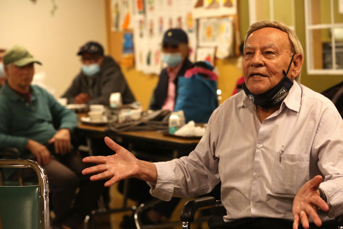 Emiliano Galan, 83, poses a question to LAPD officers and a manager with Adult Protective Services.
