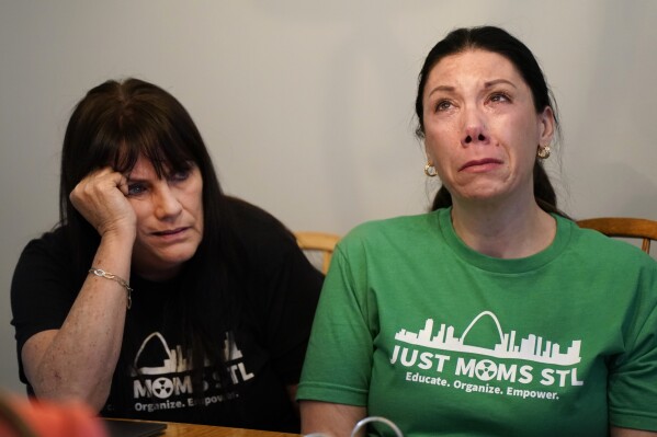 Karen Nickel, left, and Dawn Chapman, co-founders of Just Moms STL, a group created to bring attention to nuclear contamination found in the metropolitan area, pause while sharing stories Friday, April 7, 2023, in Maryland Heights, Mo. (AP Photo/Jeff Roberson)
