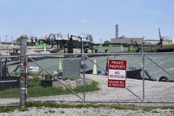 A no trespassing sign hangs on a fence around the West Lake Landfill Superfund site on Friday, April 21, 2023, in Bridgeton, Mo. Federal officials plan to remove some of the hazardous leached barium sulfate that is at the landfill and cap the rest. (AP Photo/Jeff Roberson)