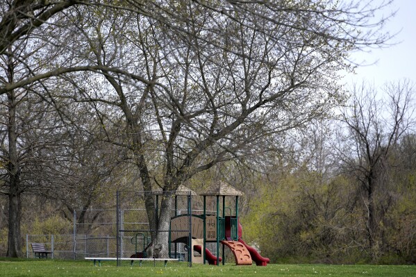 A playground sits unused outside Jana Elementary School on Friday, April 7, 2023, in Florissant, Mo. The school has been permanently closed due to its proximity to Coldwater Creek which was contaminated with nuclear material during work on the Manhattan Project. (AP Photo/Jeff Roberson)