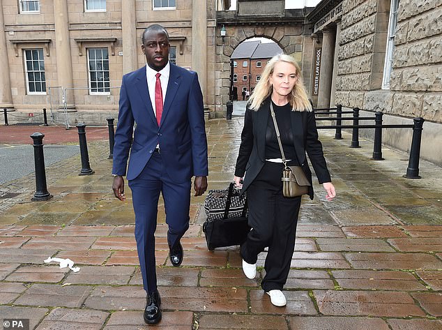 Mendy with a member of his team outside court today