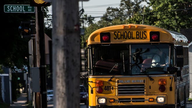 FILE - A school bus transports students on the first day of school in Oshkosh in this file photo.