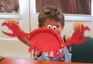 Small Fry Adventures participant holding a crafted crab
