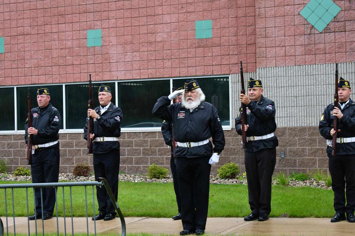 Students from Big Rapids Middle School gathered at the Big Rapids Department Of Public Safety to observe a rifle salute and moments of silence to honor lives lost in 9/11. 