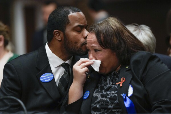 Todd Minor kisses his wife Mia Minor, both of Accokeek, Md., as they attend a Senate Judiciary Committee hearing with the heads of social media platforms on Capitol Hill in Washington, Wednesday, Jan. 31, 2024, on child safety. The Minor's son, Matthew Minor, died after a TikTok "choking challenge" in 2019. (AP Photo/Susan Walsh)