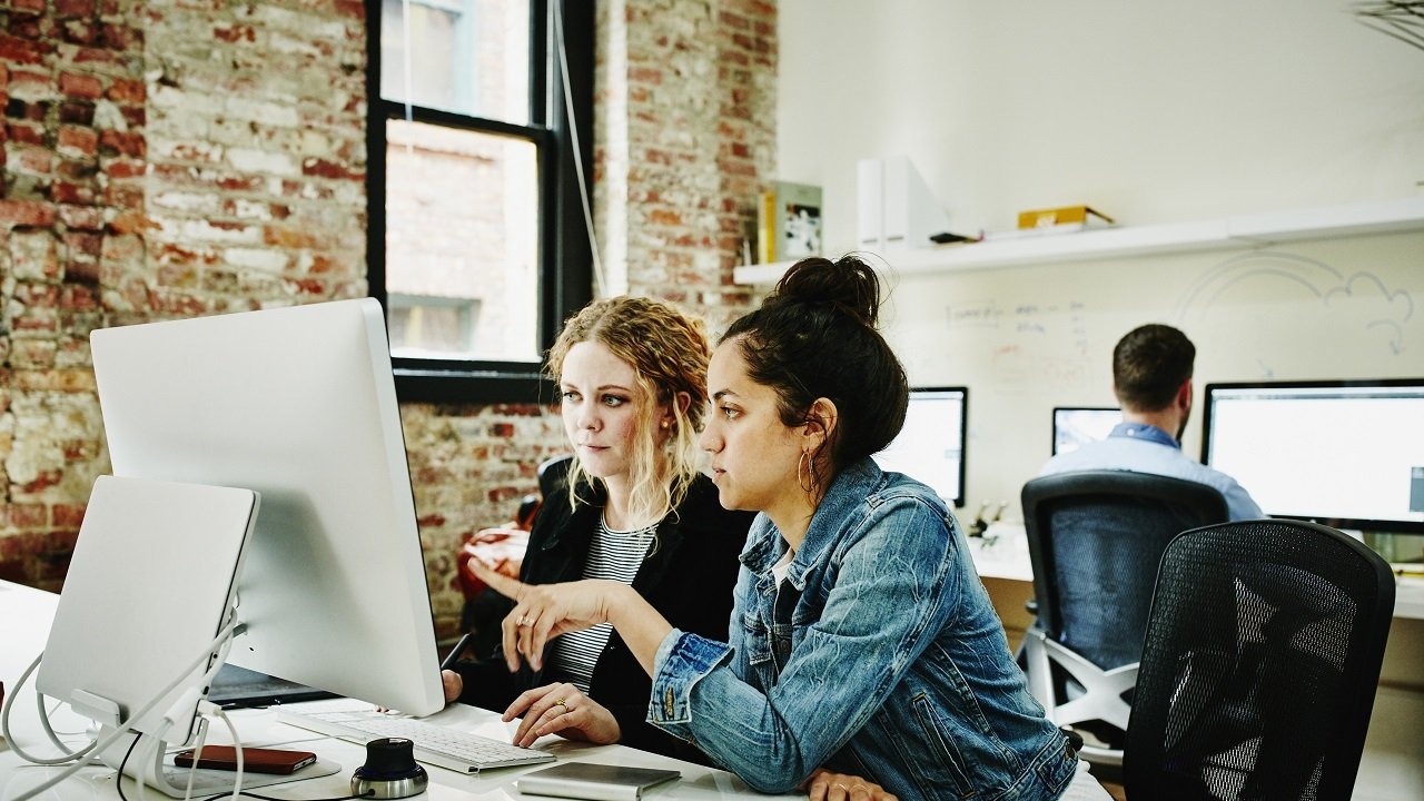 Two women looking at a monitor
