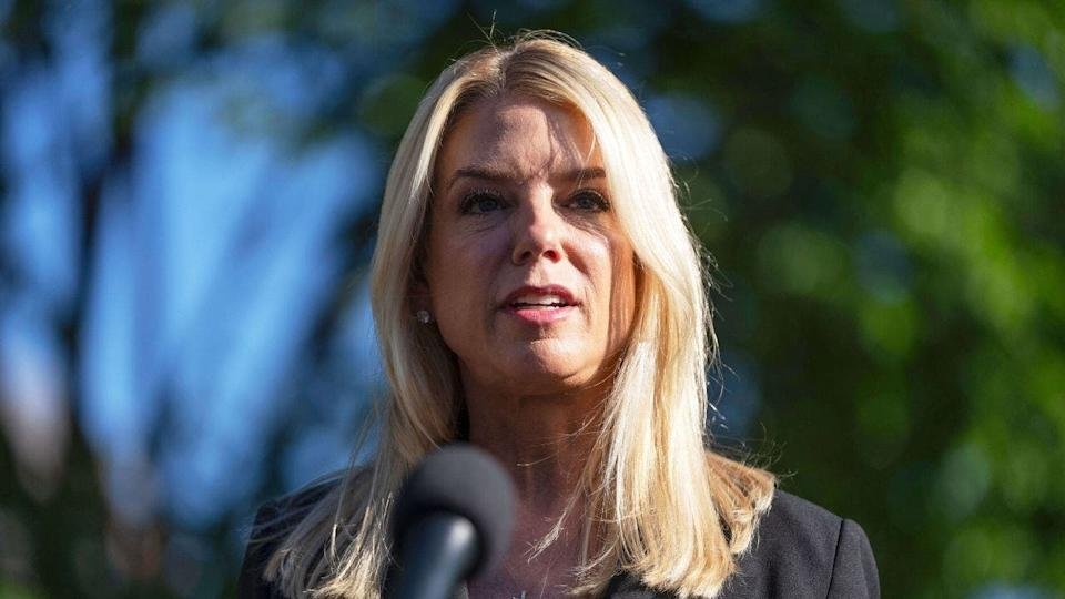 Pam Bondi at a microphone