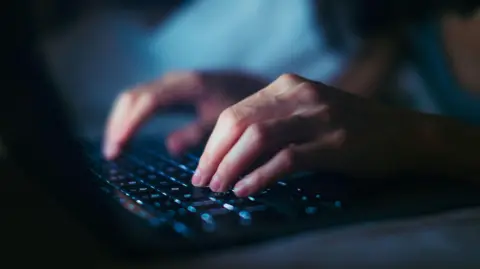 Getty Images Hands at a computer keyboard