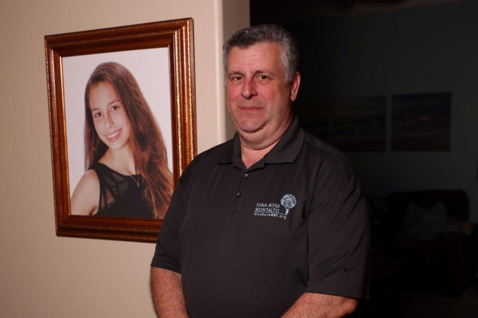 Tony Montalto stands next to a photo of his daughter, Gina, at his home in Parkland, Florida. Gina was shot to death as she worked on a project in the hallway at Marjory Stoneman Douglas High School on Feb. 14, 2018. (John McCall/South Florida Sun Sentinel/Tribune News Service/Getty Images)