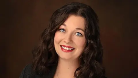 Sysdig Crystal Morin smiles and looks into the camera.