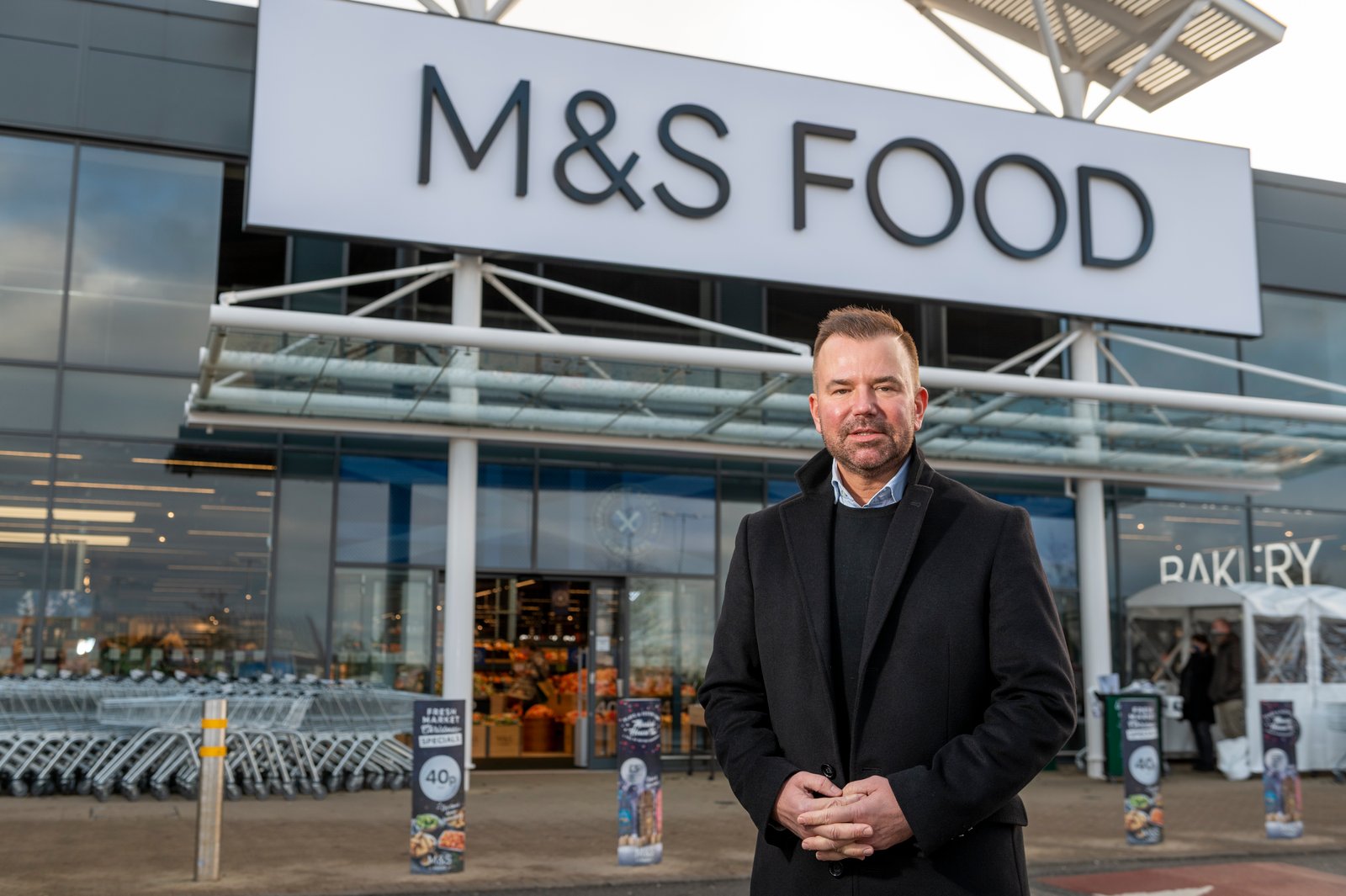 Stuart Machin, Marks and Spencer Food Managing Director, standing outside a new M&S Food store.