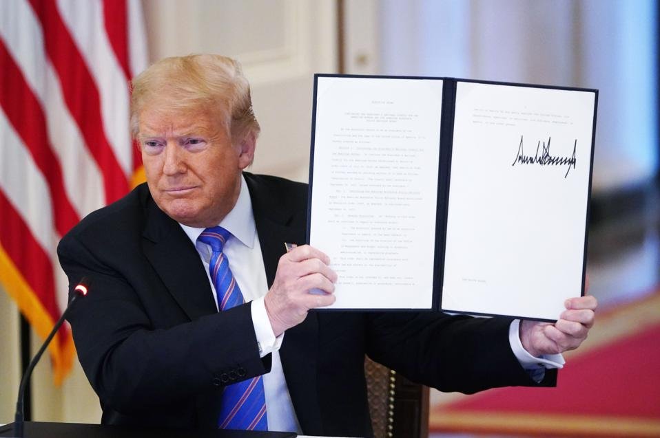 President Donald Trump Shows An Executive Order 