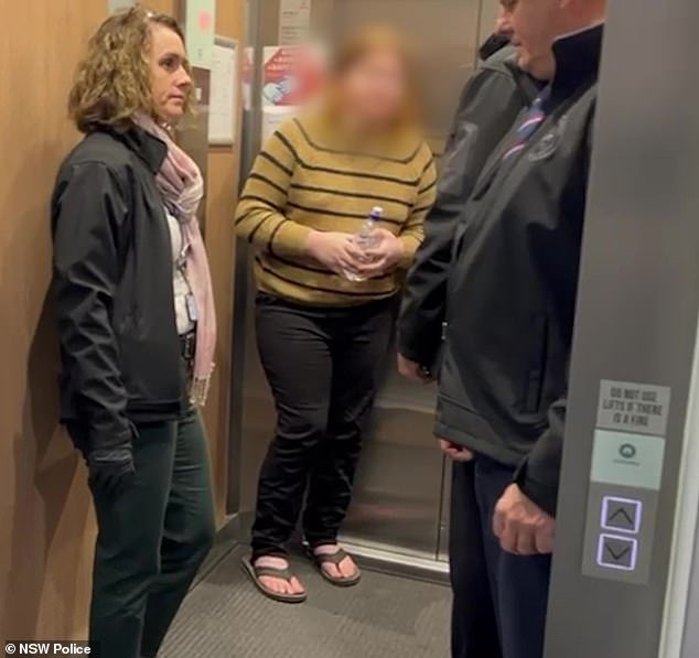 She clutched a water bottle and walked with a limp as she made her way outside