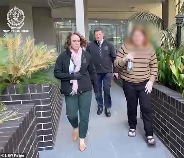 Kingston (pictured, right) was marched out to a waiting police van by detectives