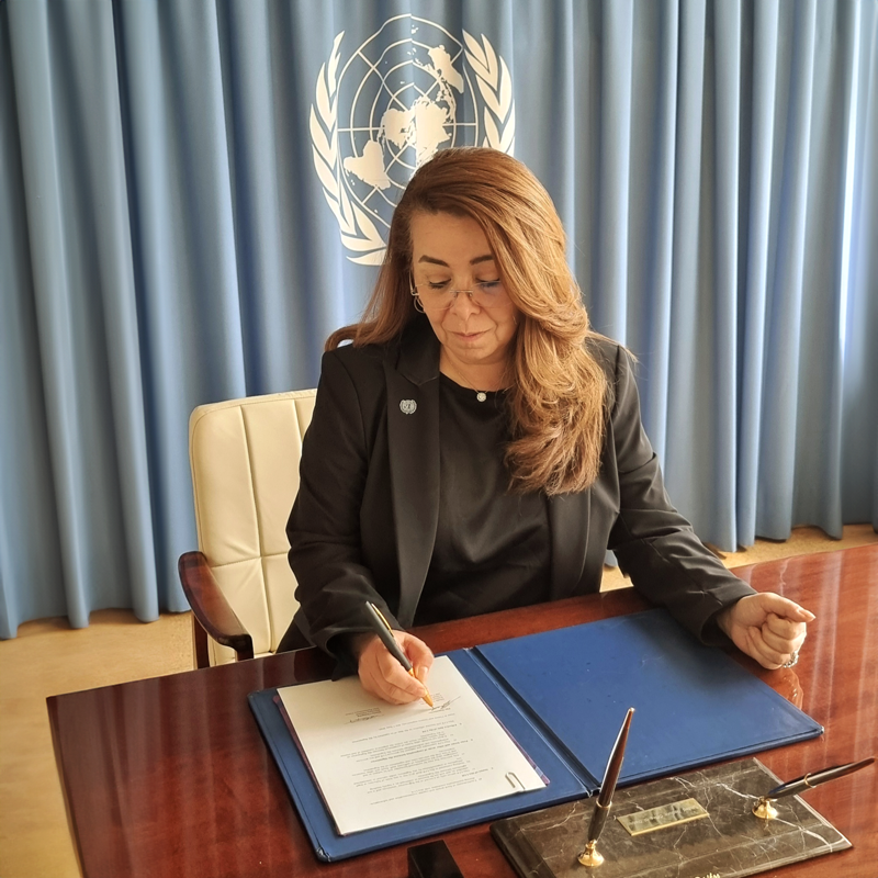 Woman signging a paper 