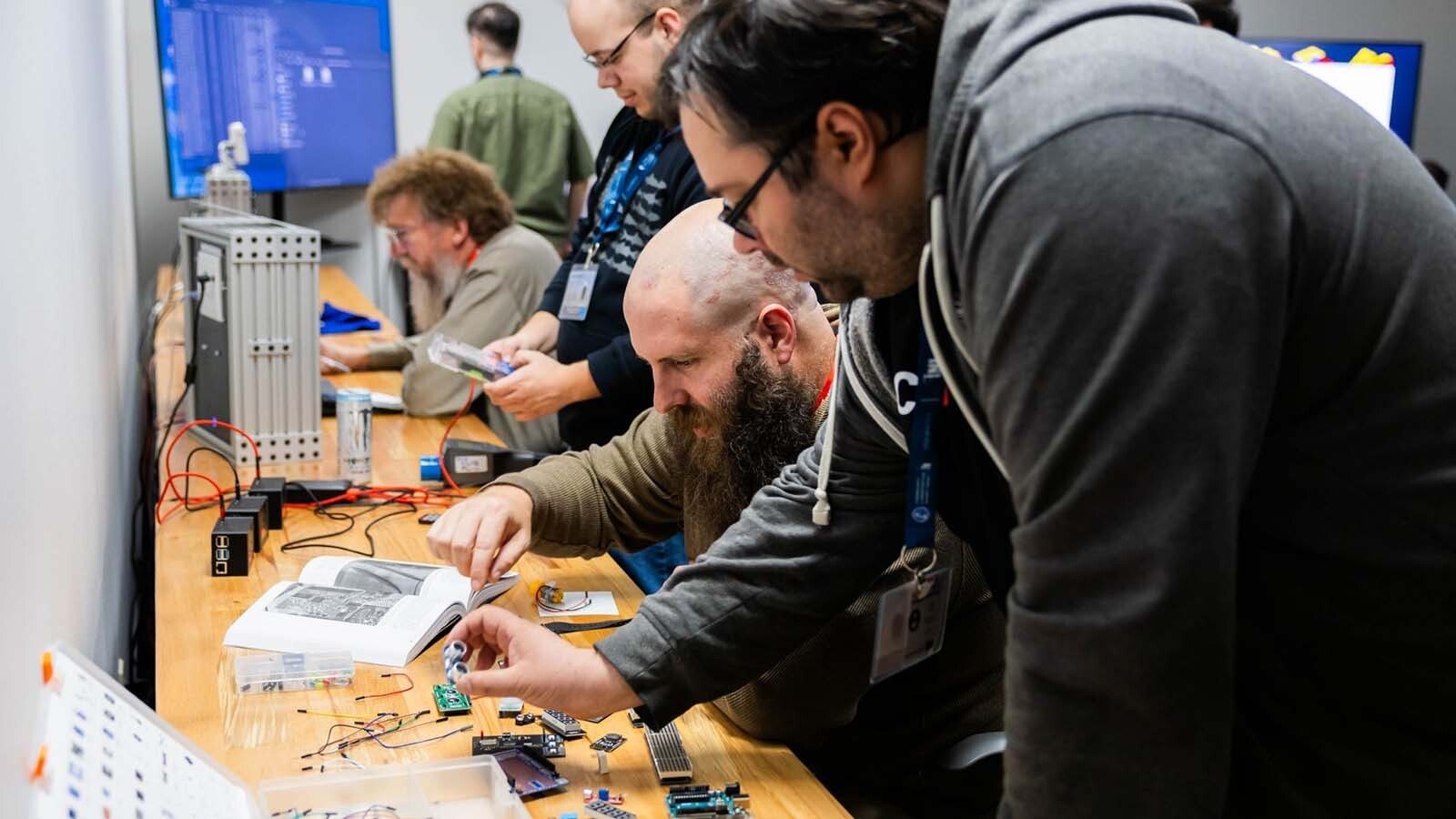 Cybersecurity specialists must figure out the significance of multiple objects and clues in an escape room exercise as part of ICS Cybersecurity Lab Training.