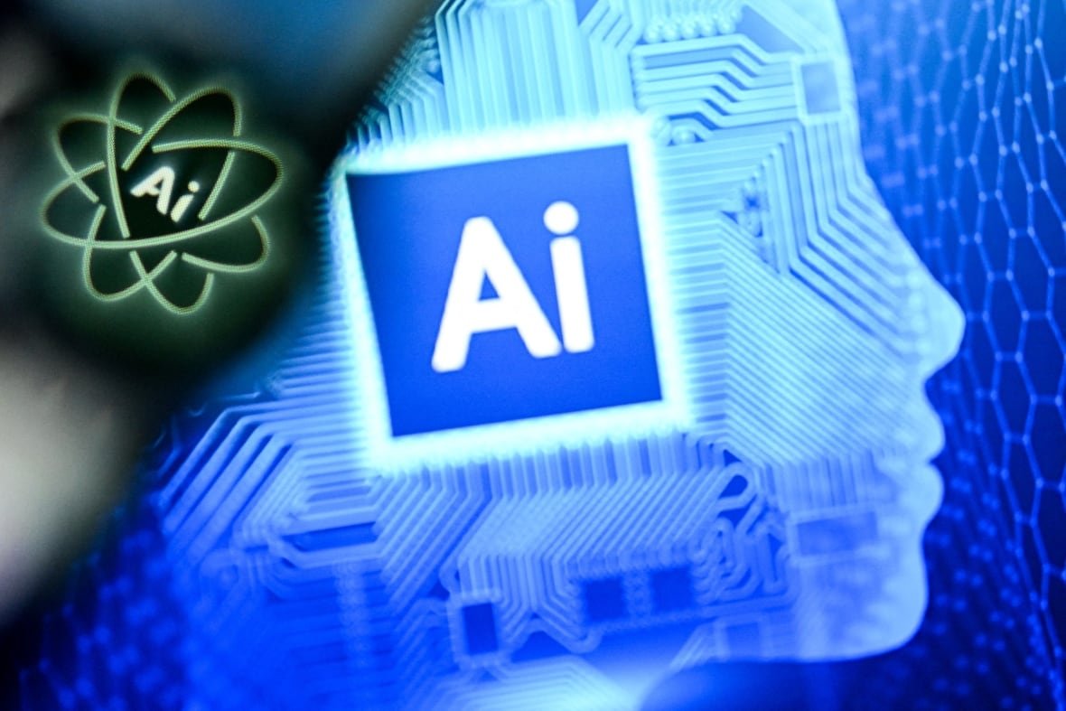The word "AI" in a blue square atop a silhouette of someone's face, and the word "AI" in atop a green nucleus