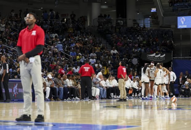 Monterrey Security workers stand on the court during a stoppage in the Sky-Dream game Thursday, Aug. 7, 2025, at Wintrust Arena. (Eileen T. Meslar/Chicago Tribune)