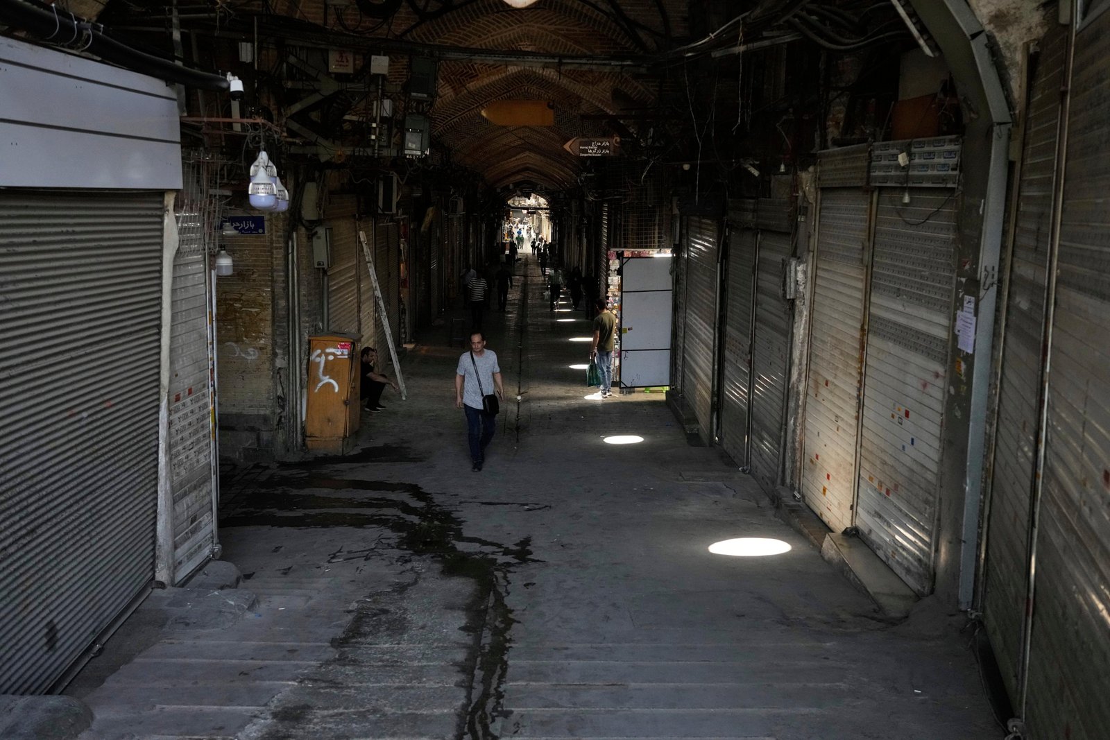 FILE.- Few pedestrians walk along the historic Grand Bazaar as...