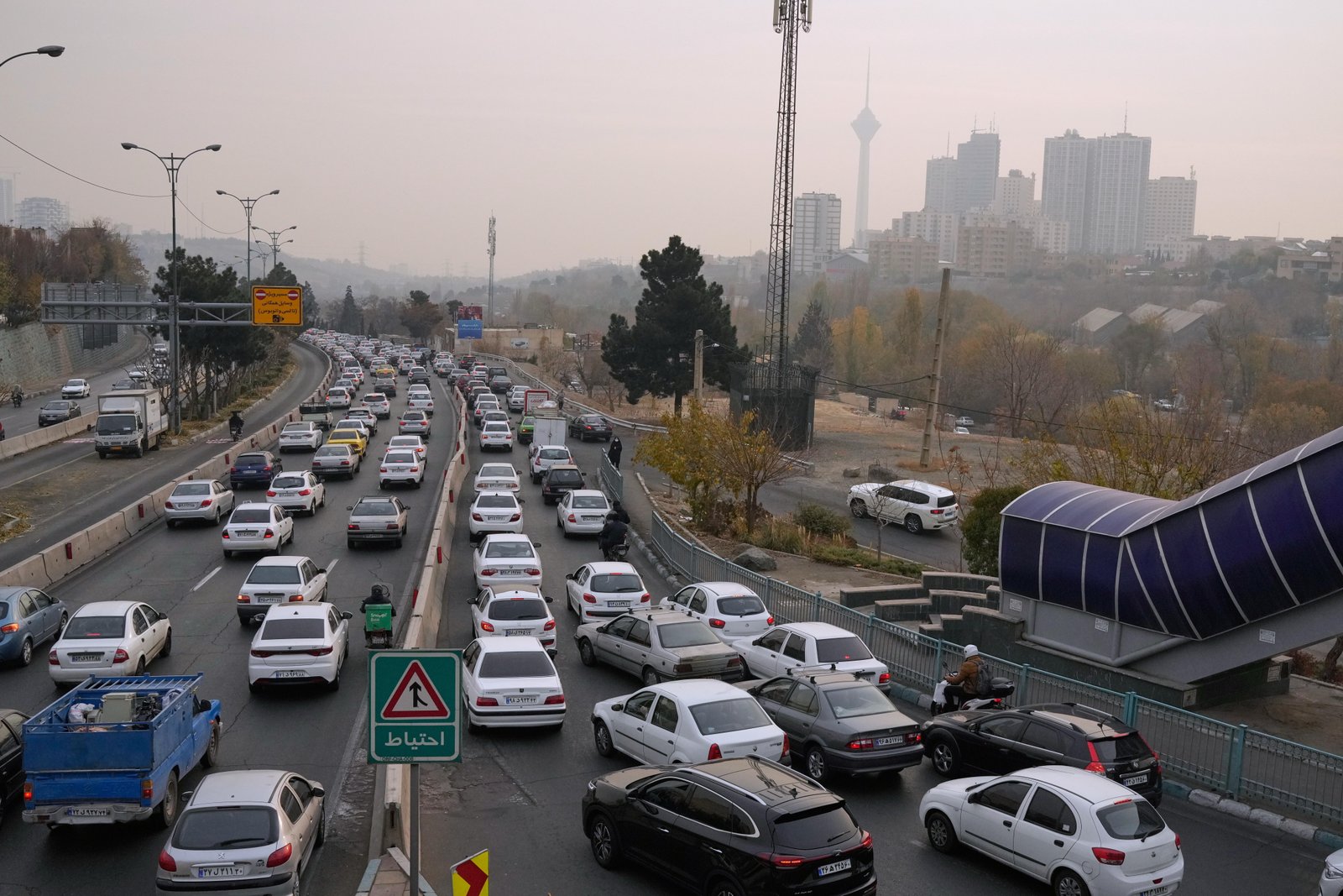 FILE.- Cars drive in an afternoon traffic jam in a...